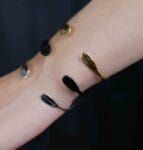 A woman's arm adorned with three bracelets 'Silver Foliage' showcasing the elegance of nature-inspired designs in silver.