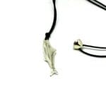 Close-up of polished silver Boops fish pendant, showcasing its ocean-inspired craftsmanship and big-eye detail.