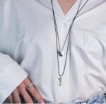 Woman wear the 'Bottom' ocean jewelry necklace with seashell design, ideal for summer fashion and beach lovers.